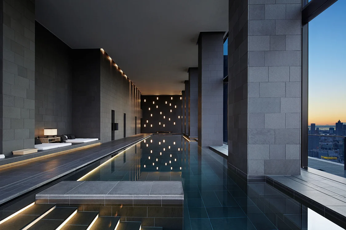 Heated indoor pool at Aman Tokyo with views over the city skyline