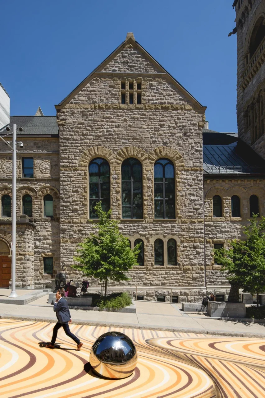 Mirrored sphere on the mural in front of a stone museum building