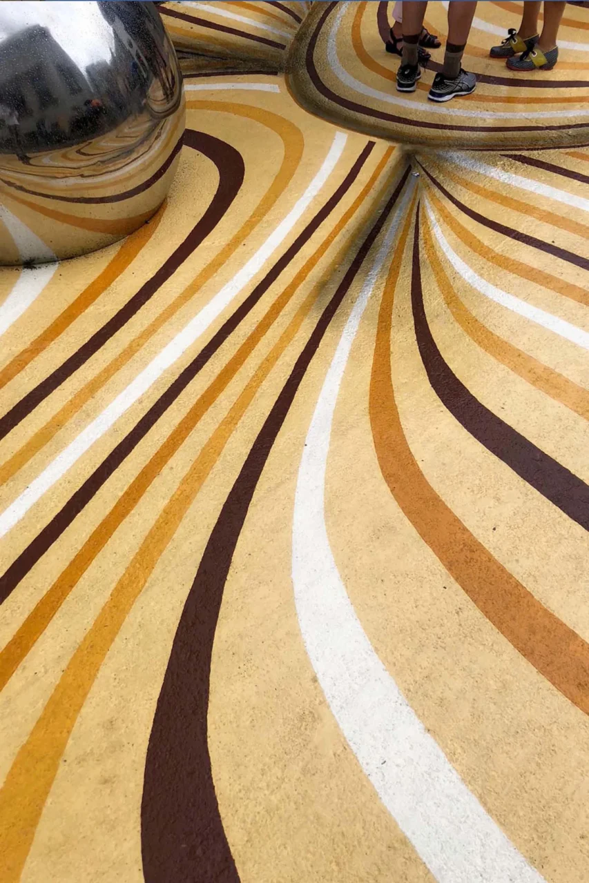 Close view of the curving painted lines around a sphere