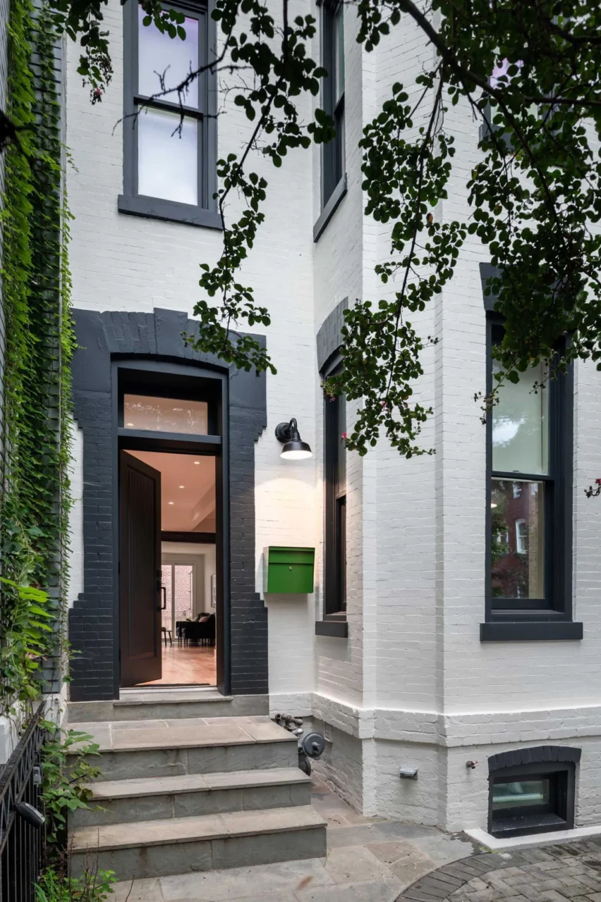 Painted brick exterior and front door of the row house