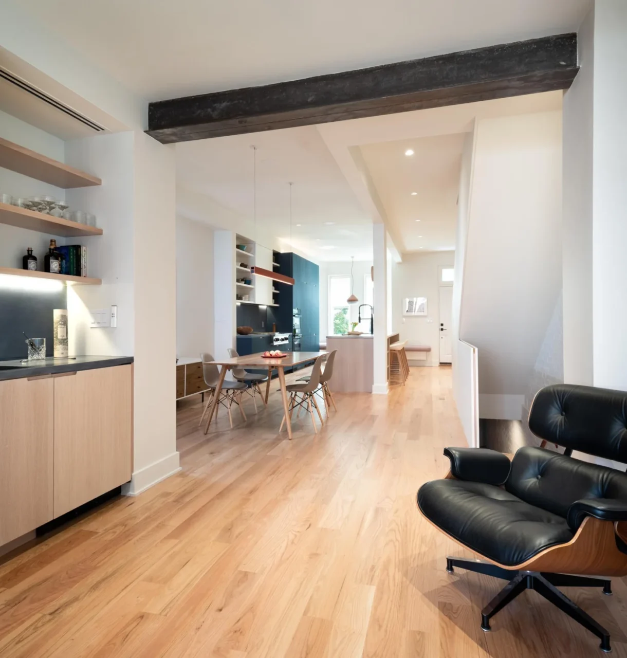 Open plan kitchen and dining area with wood floors after the remodel