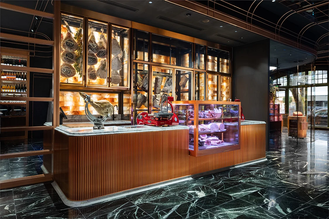 Shop interior with curving forms and a solid-wood butcher block