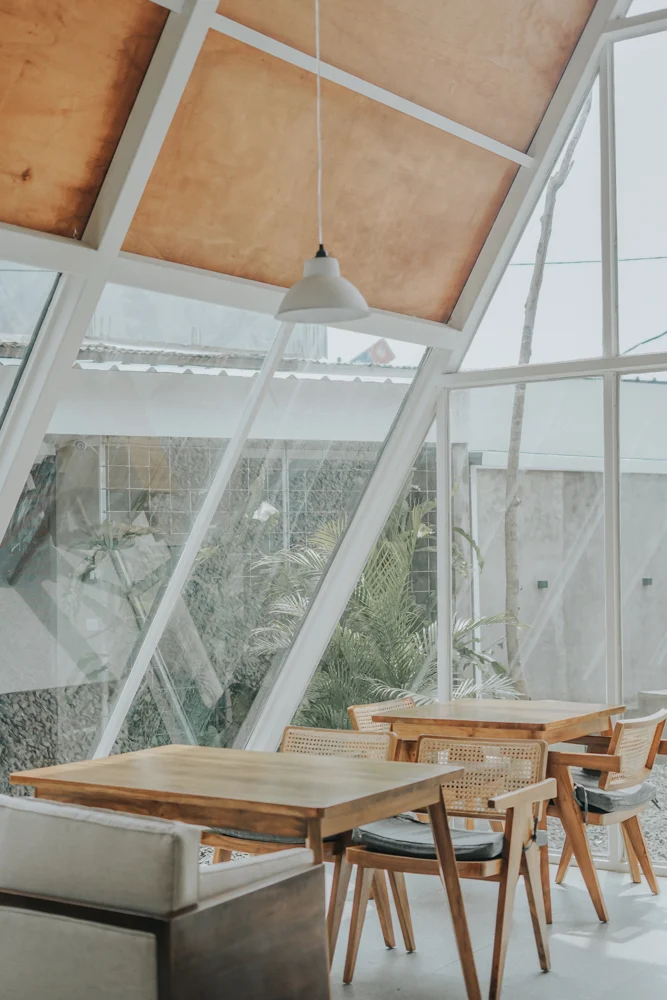 Exposed timber framing drawing the eye up to the ridge of the cafe