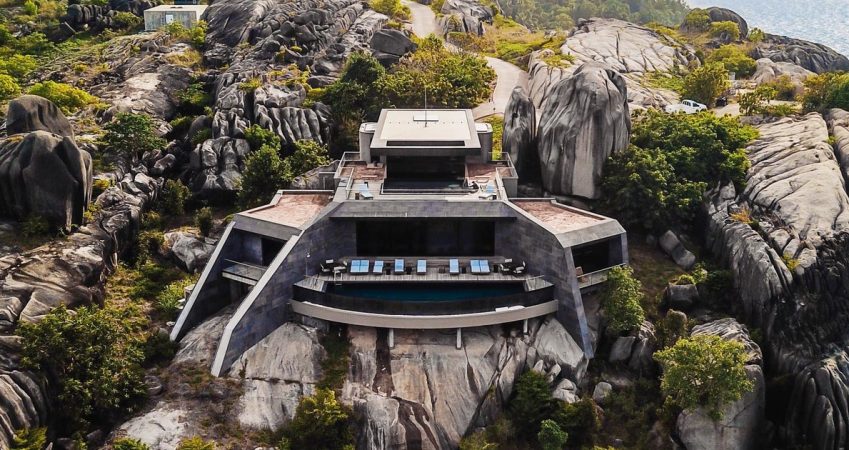 a-collection-of-modern-homes-are-built-into-these-weathered-granite-cliffs