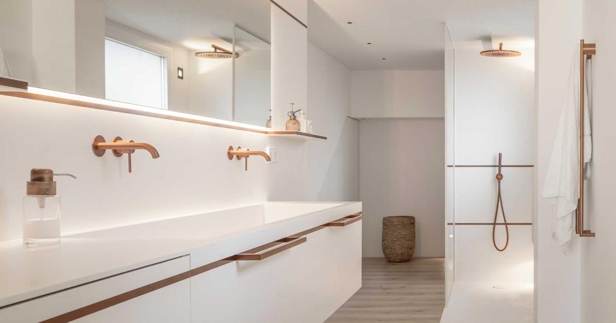 copper-tones-are-balanced-by-white-corian-in-this-minimalist-bathroom