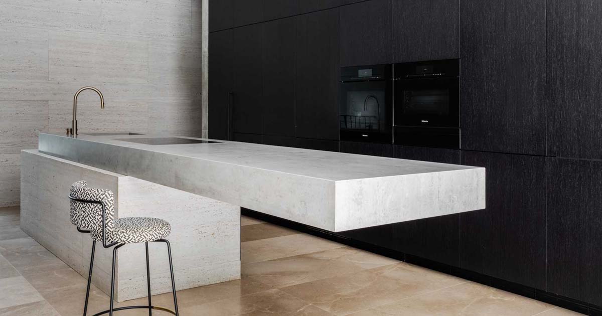 a-cantilevered-island-is-a-dramatic-feature-in-this-minimalist-kitchen