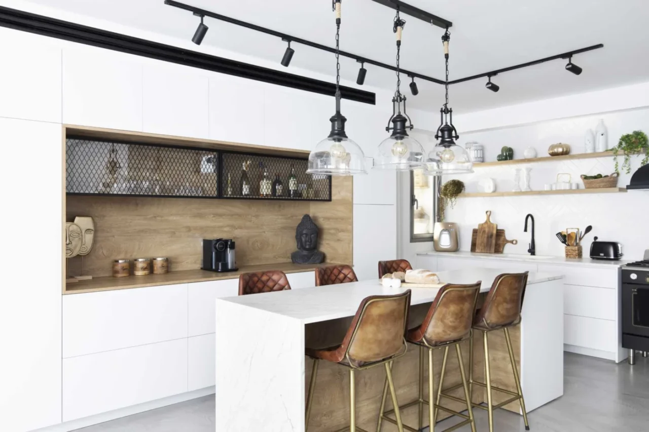 White kitchen with a large island that doubles as a dining table, by OD interior design
