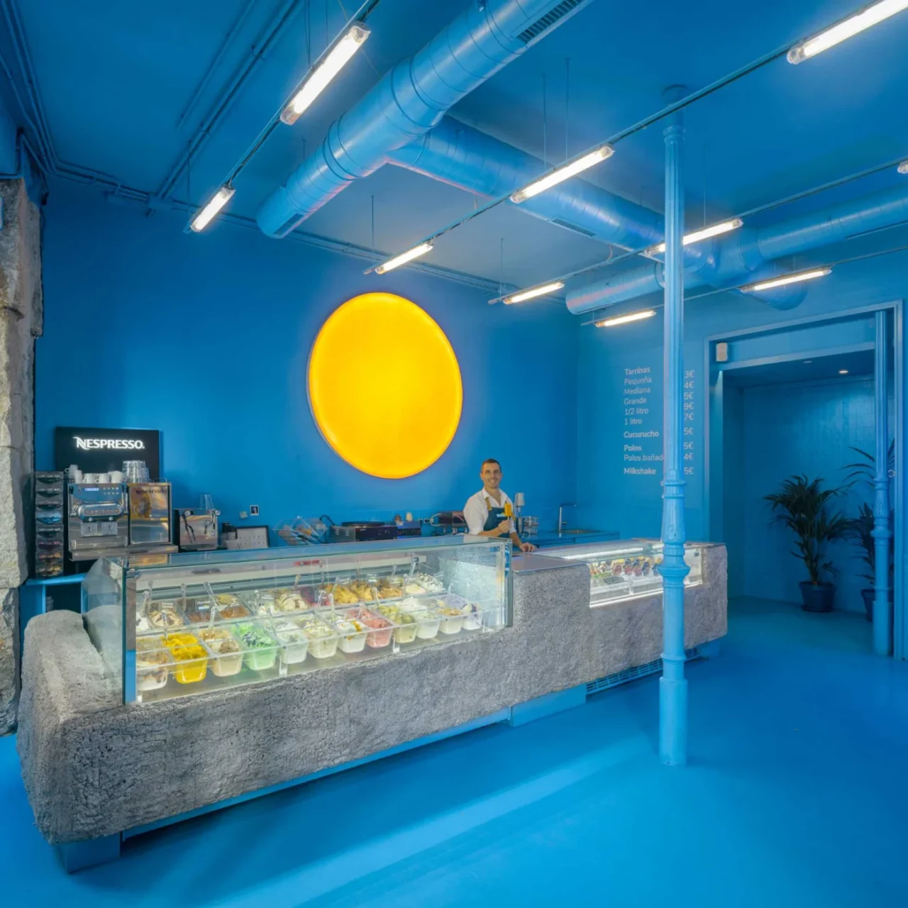 Bright blue interior of the BRANDO ice cream shop in Madrid