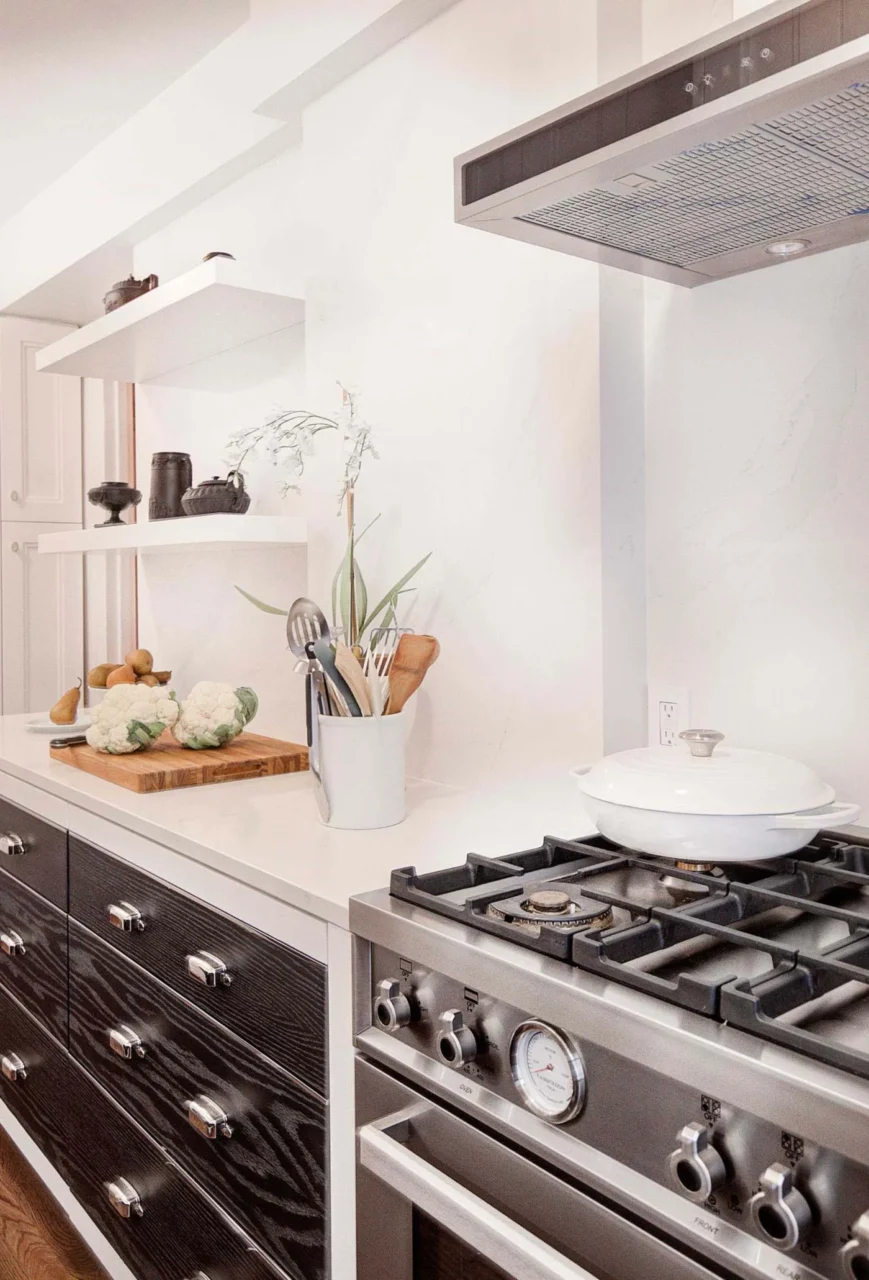 Oven on the opposite wall of the black and white kitchen