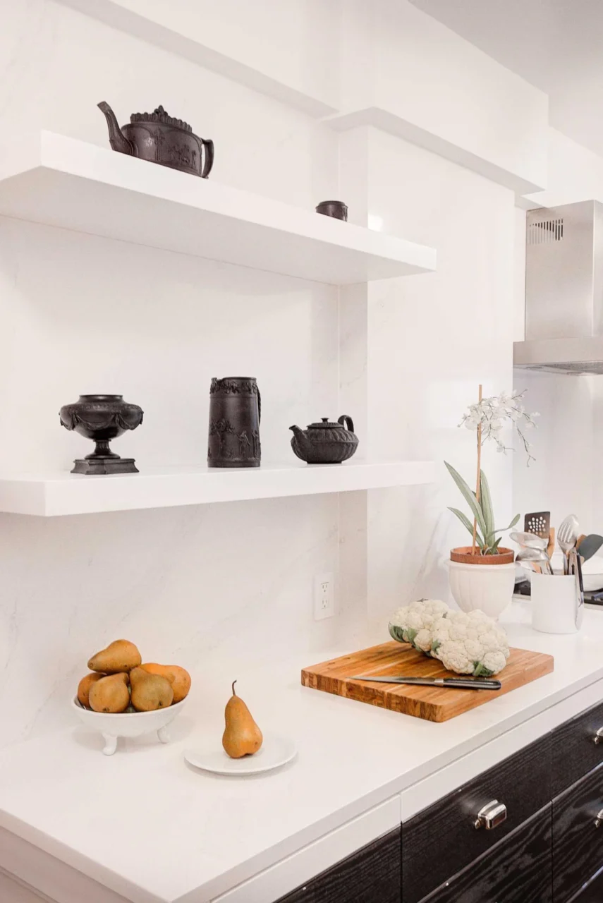 Pair of floating white shelves blending into the wall