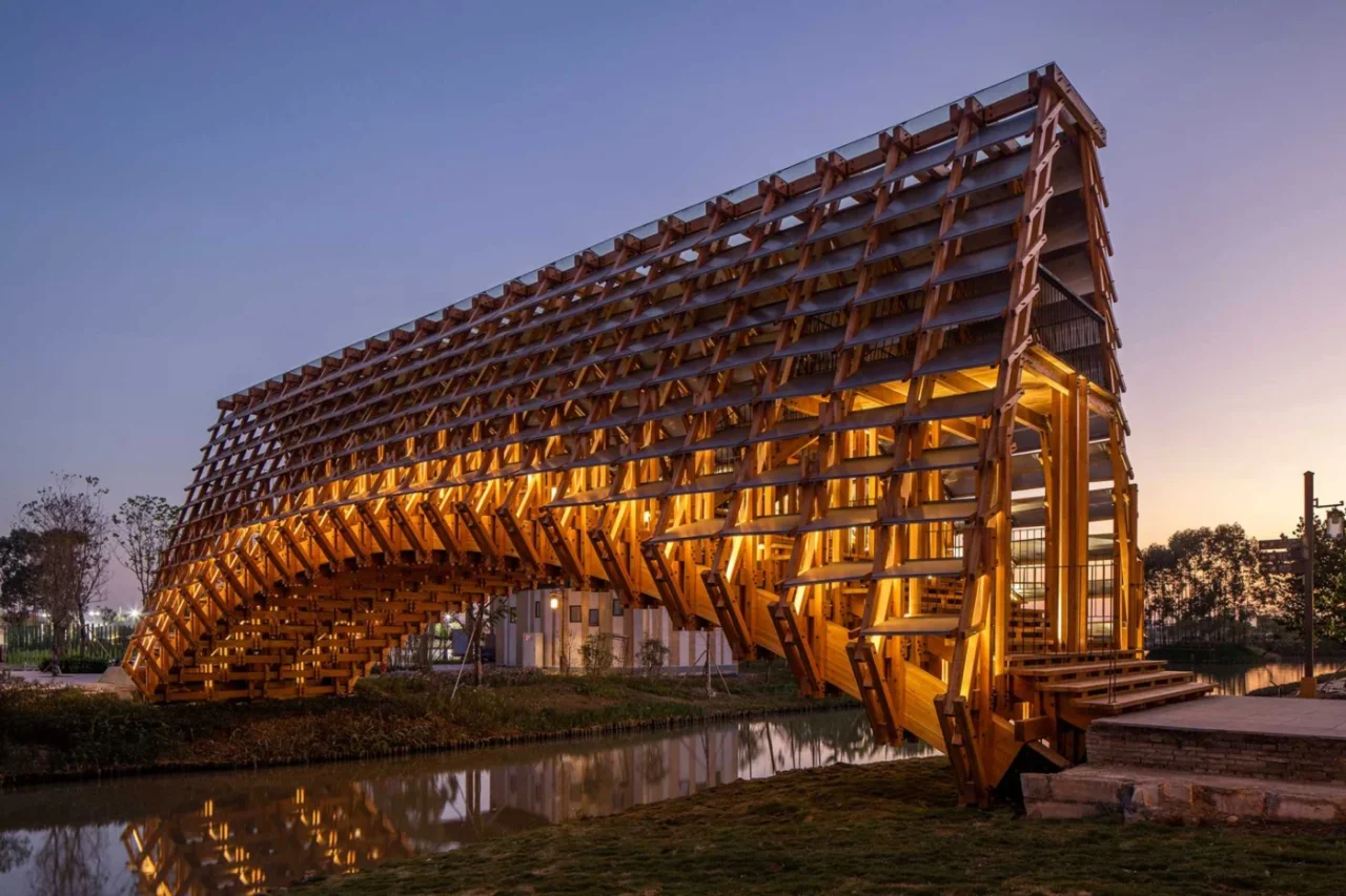 Arched timber pedestrian bridge by LUO studio at the Gulou Waterfront Resort in Jiangmen, China