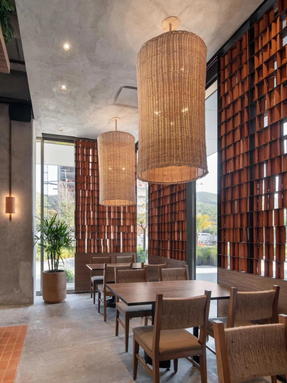 Red clay tile accents set against raw concrete