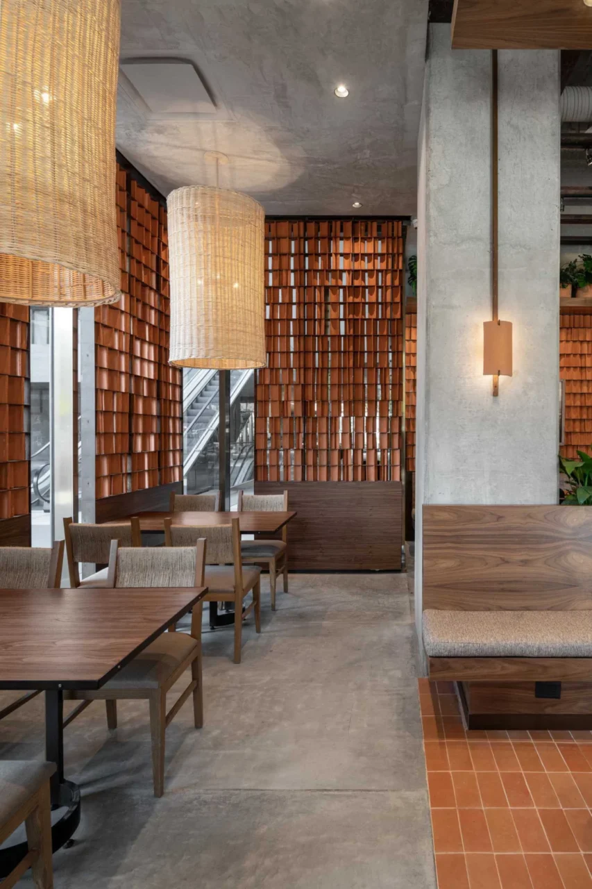 Curved clay tiles casting shadows across the cafe interior