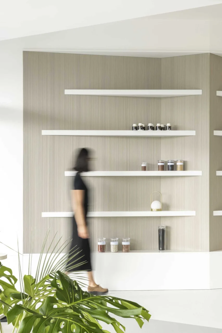 White triangular display shelves fitted to an angled wall in the clinic reception