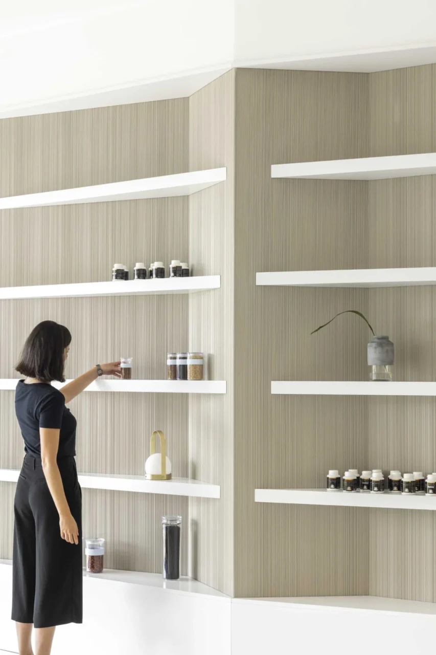 Close view of the white angular shelving unit in the reception area
