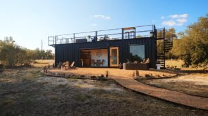 a-spiral-staircase-leads-to-the-rooftop-deck-on-this-shipping-container-home