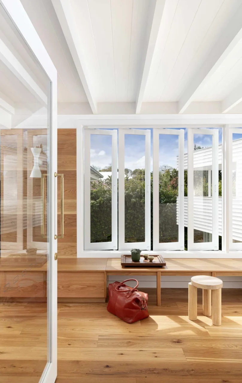 Entryway with a built-in storage bench beneath the windows