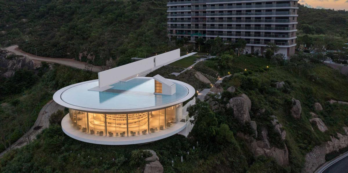 a-shallow-pool-sits-on-top-of-this-modern-library