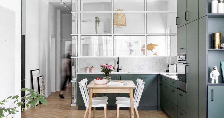 a-glass-enclosed-home-office-is-tucked-in-behind-the-kitchen-in-this-apartment