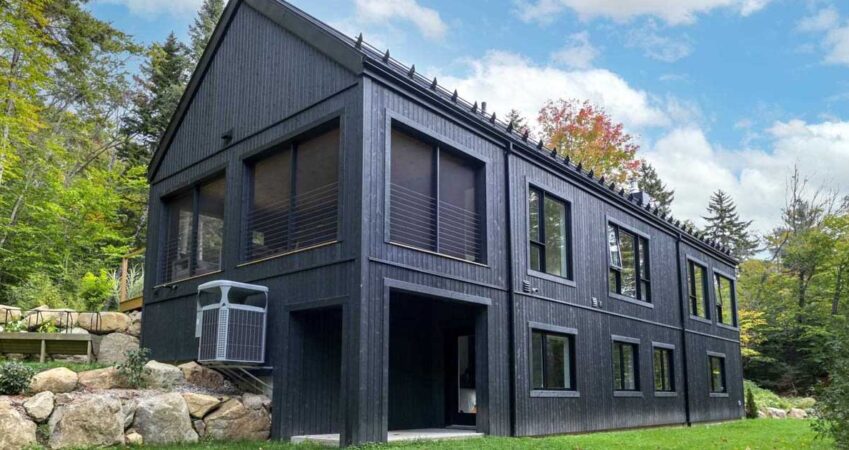 all-black-wood-siding-creates-a-striking-exterior-for-this-new-house