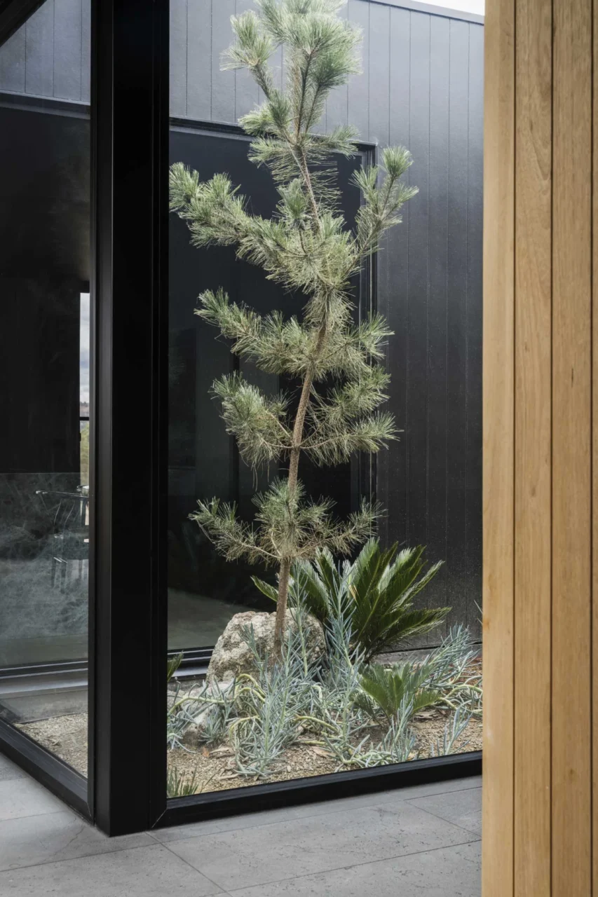 Window framing the landscape from a hallway of the U-shaped house