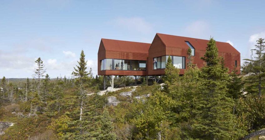 rusty-corrugated-steel-covers-the-exterior-of-this-home-on-the-edge-of-a-forested-hillside