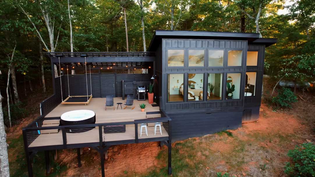 black-board-and-batten-siding-covers-the-exterior-of-this-cabin-in-the-mountains