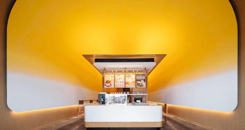 this-pancake-cafe-used-a-bold-yellow-to-highlight-its-curved-ceiling