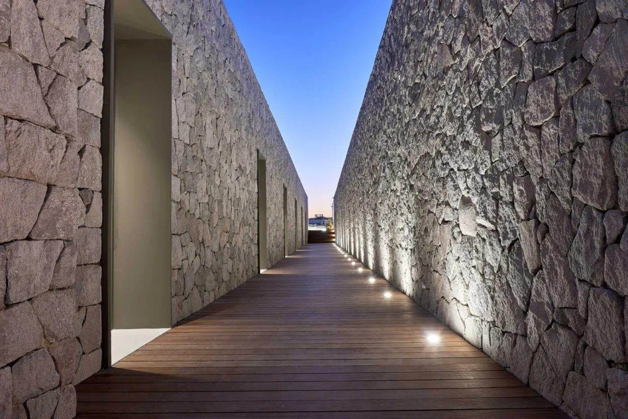 Grey stone walls made with local raw materials, Cave Suites Milos, Plaka, Greece