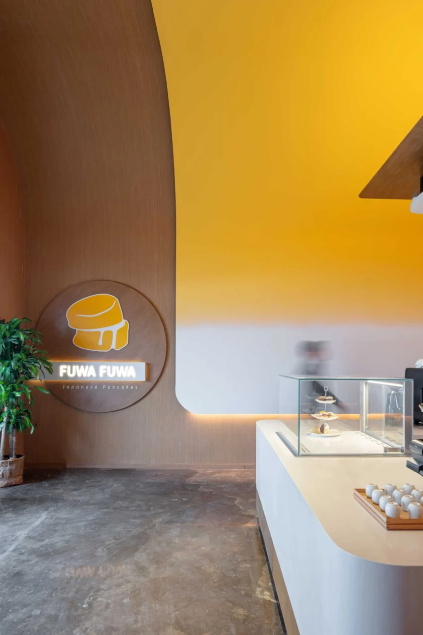 Hidden lighting along the curved yellow ceiling