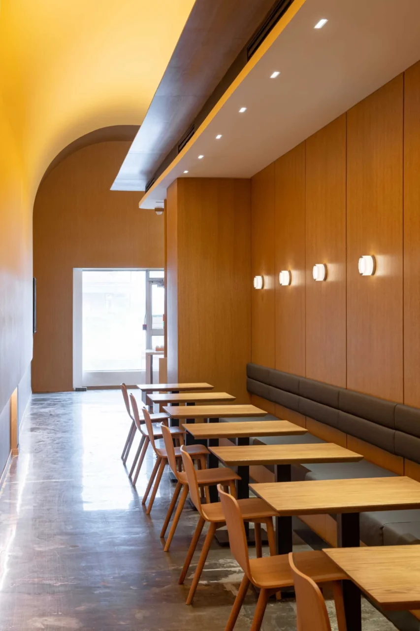 Banquette seating in an alcove with wood tables and chairs