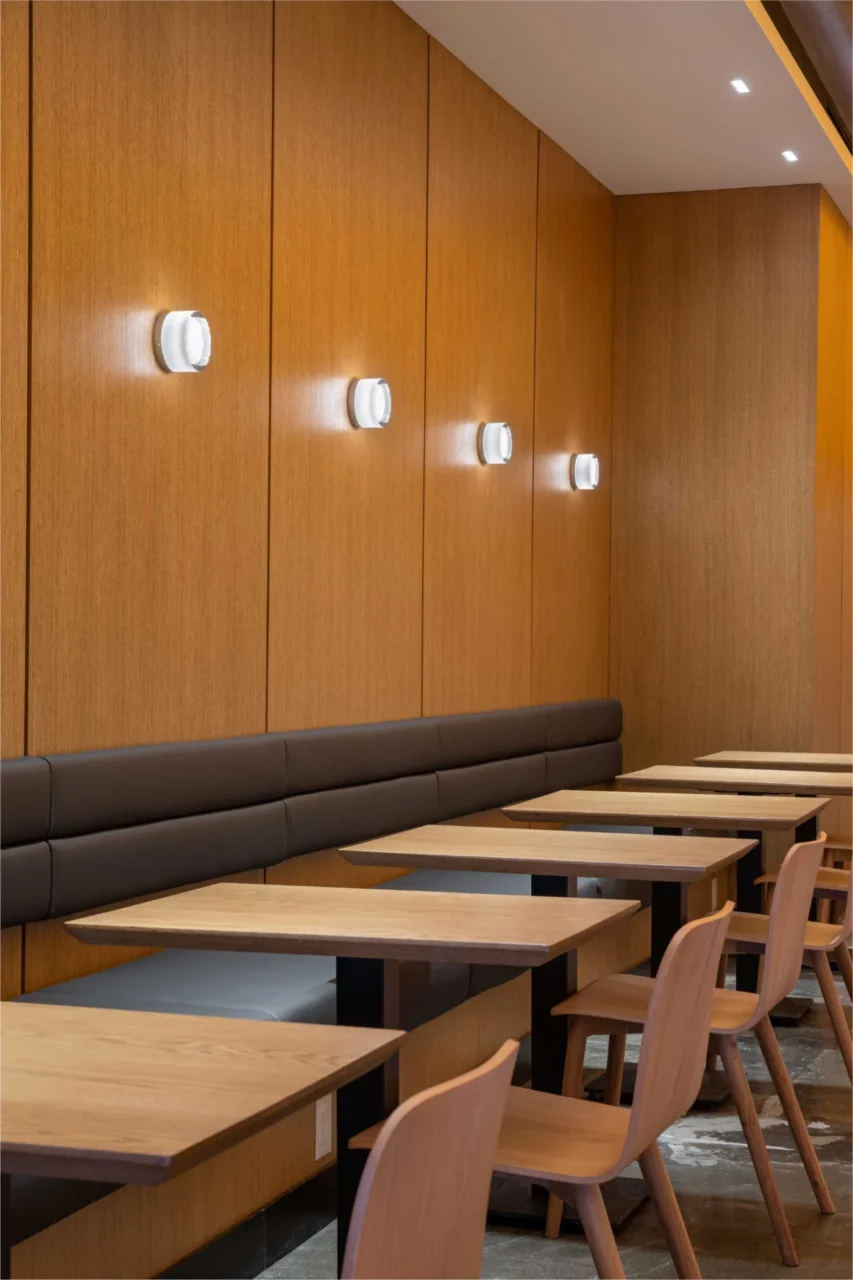 Upholstered banquette with wall sconces