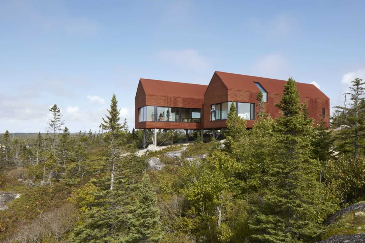 House clad in weathered corrugated steel on a granite hilltop in Nova Scotia