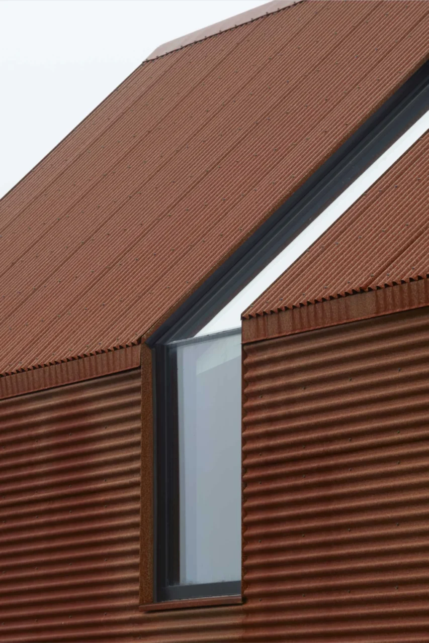 Corrugated steel volume of the house above the Atlantic coast