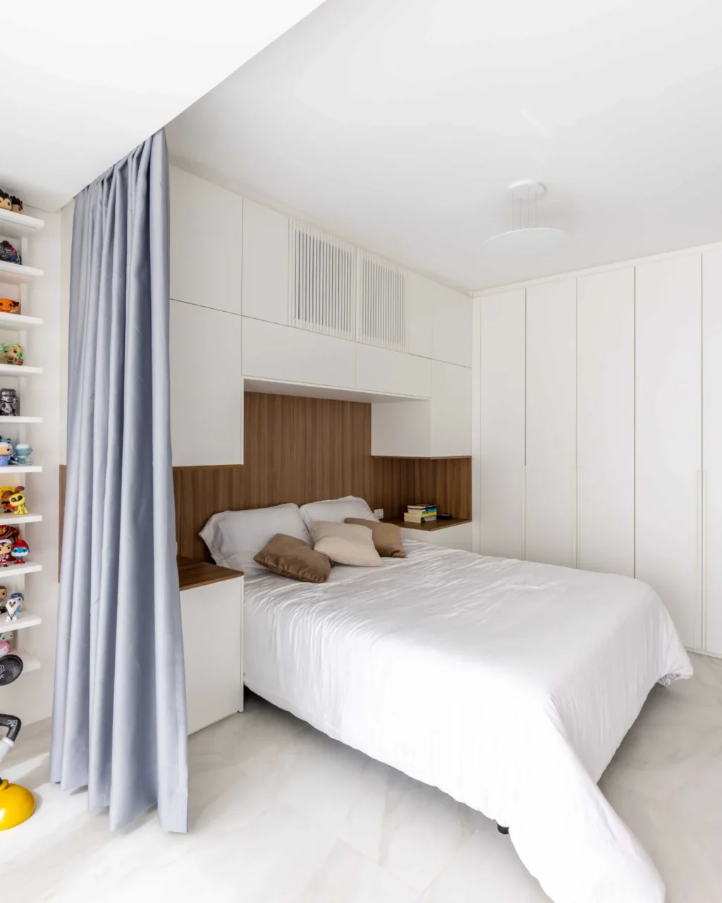 Bedroom with storage walls and a wood headboard