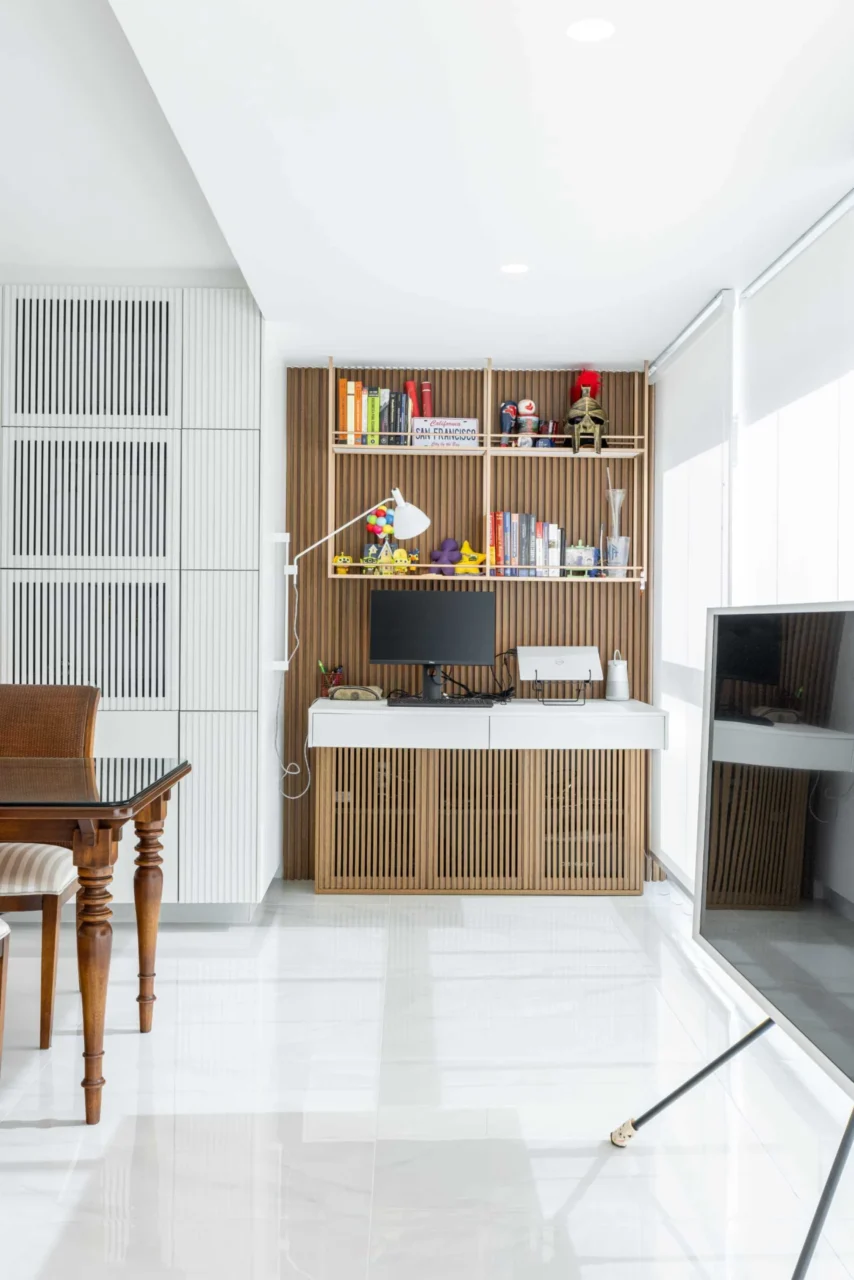 Wood accent wall by the windows behind a desk