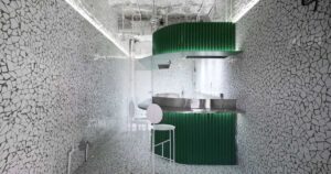 a-broken-tile-mosaic-covers-the-floor-and-walls-of-this-taqueria