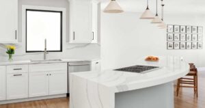 an-s-shaped-kitchen-island-flows-through-this-remodeled-home