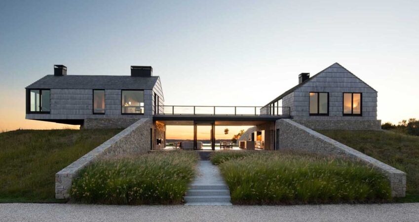 two-shingle-covered-cottages-connected-by-a-living-room-and-kitchen-in-between