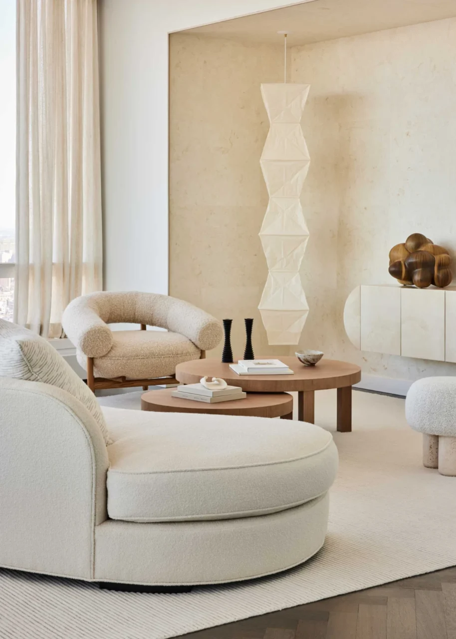 Curved sofa around custom coffee tables designed by Jessica Gersten