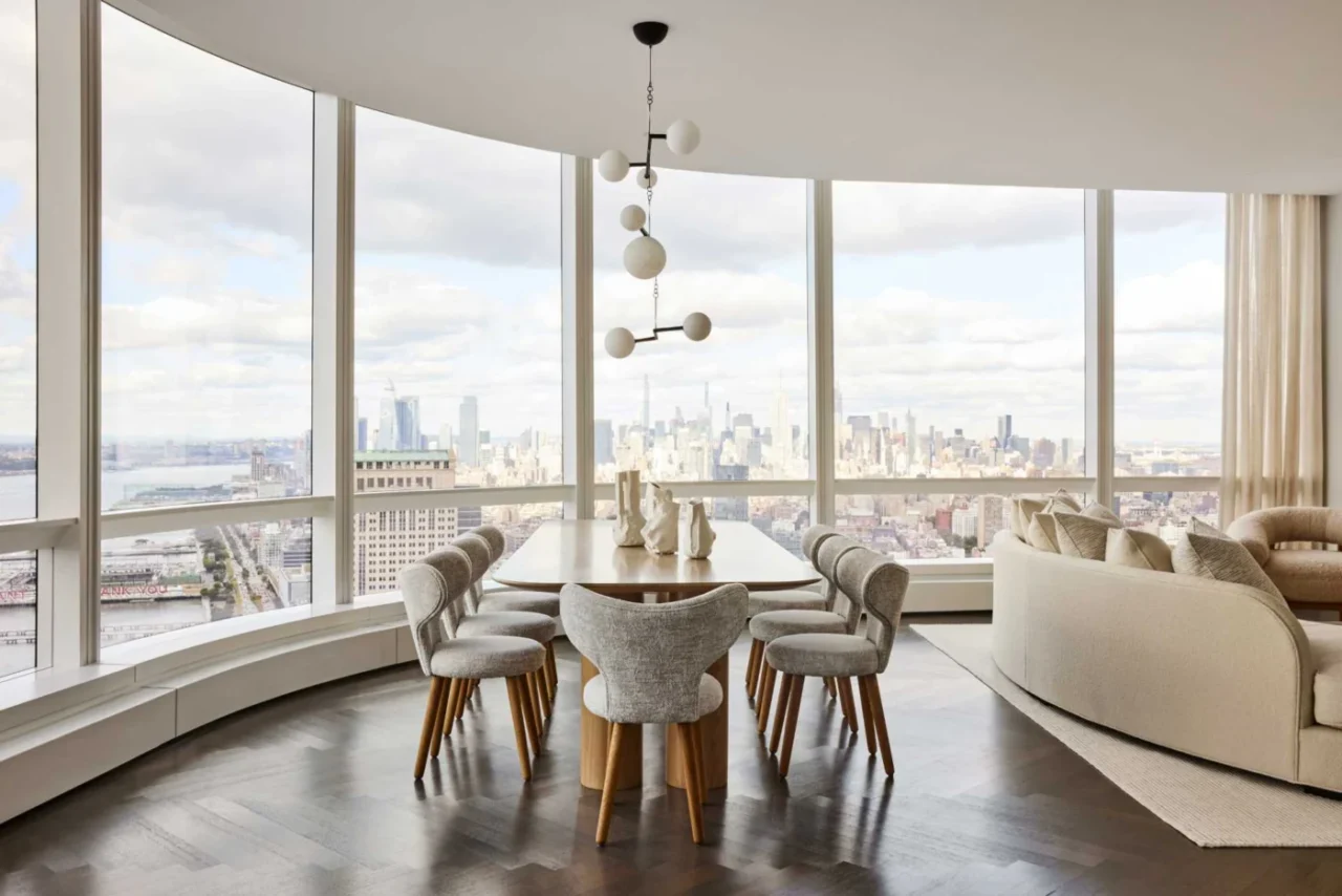 Mobile light over an oak dining table with curved wing dining chairs