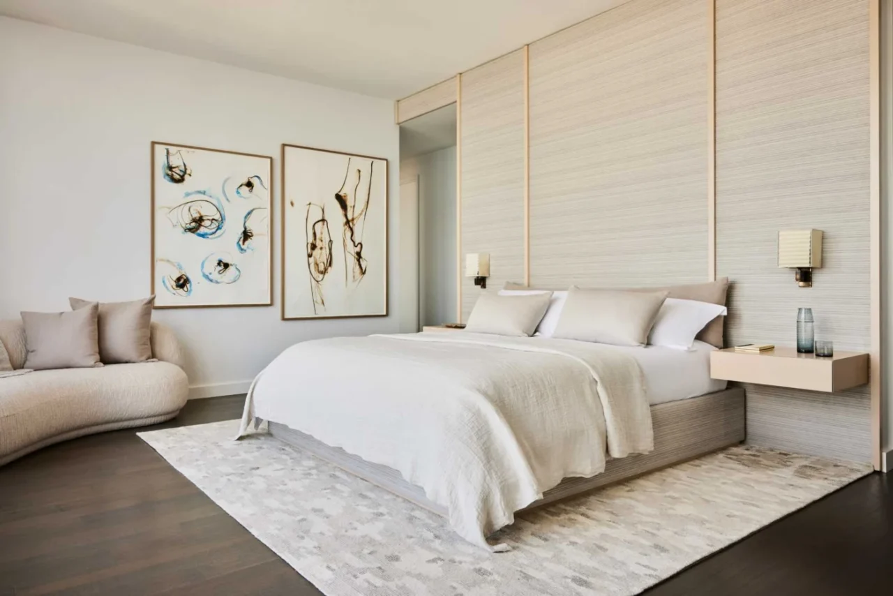 Main bedroom with a custom headboard wall and pale oak panelling