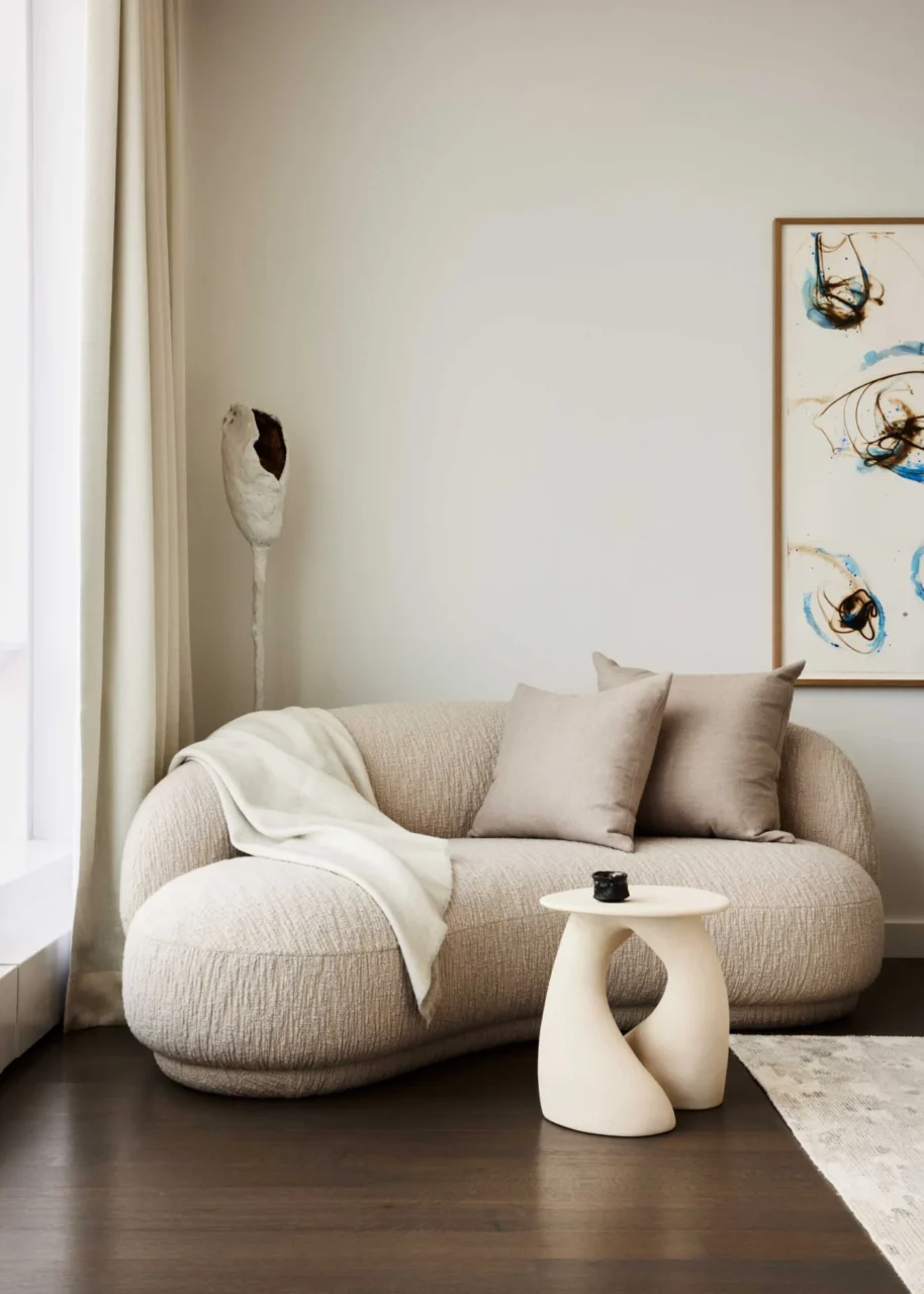 Bedroom with a small sitting area in neutral tones