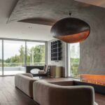a-curved-accent-wall-wraps-around-from-the-fireplace-to-the-ceiling-inside-this-home