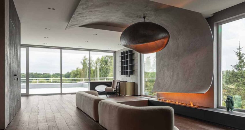 a-curved-accent-wall-wraps-around-from-the-fireplace-to-the-ceiling-inside-this-home