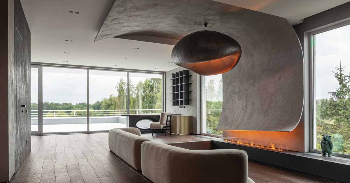 a-curved-accent-wall-wraps-around-from-the-fireplace-to-the-ceiling-inside-this-home