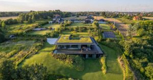 a-large-green-roof-covers-this-riverside-home