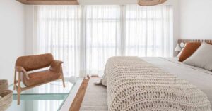 this-bedroom-with-a-partial-glass-floor-looks-down-to-the-living-room-below