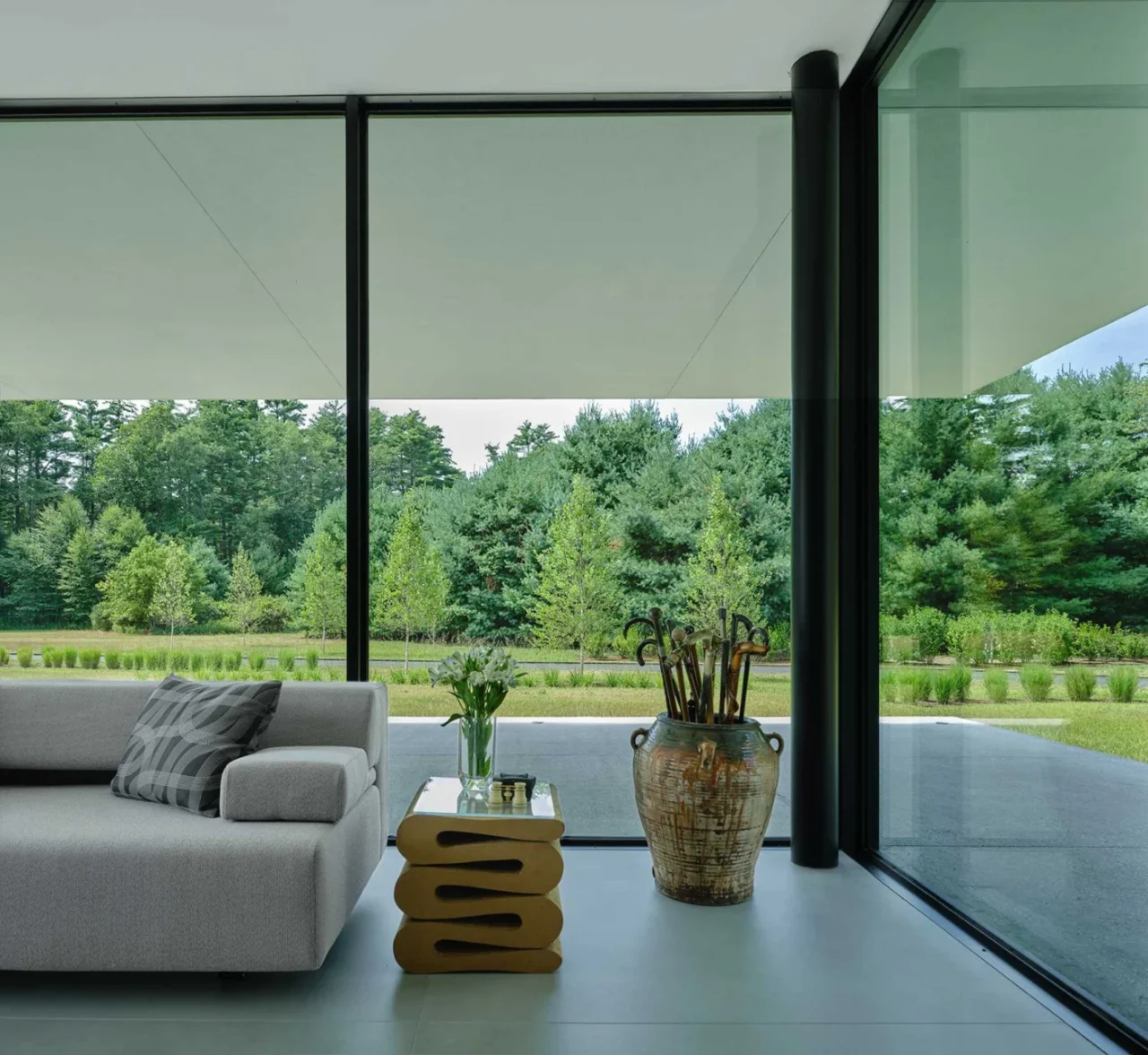 Guest room with floor-to-ceiling windows framing the trees