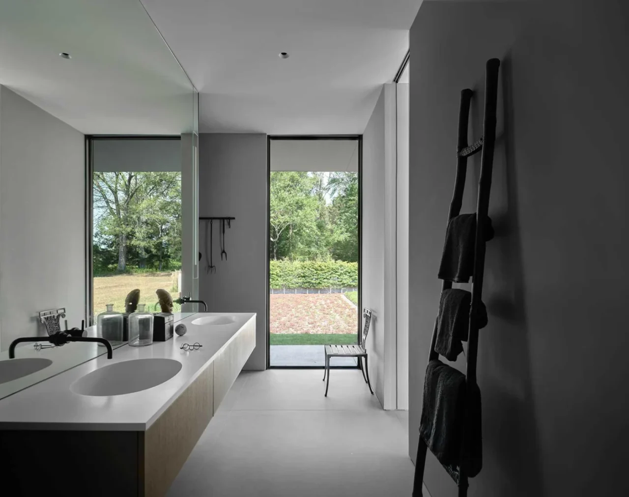 Primary bathroom with a floating double vanity and a tall vertical window